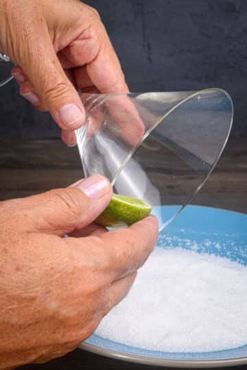 Lime wedge on martini glass rim.