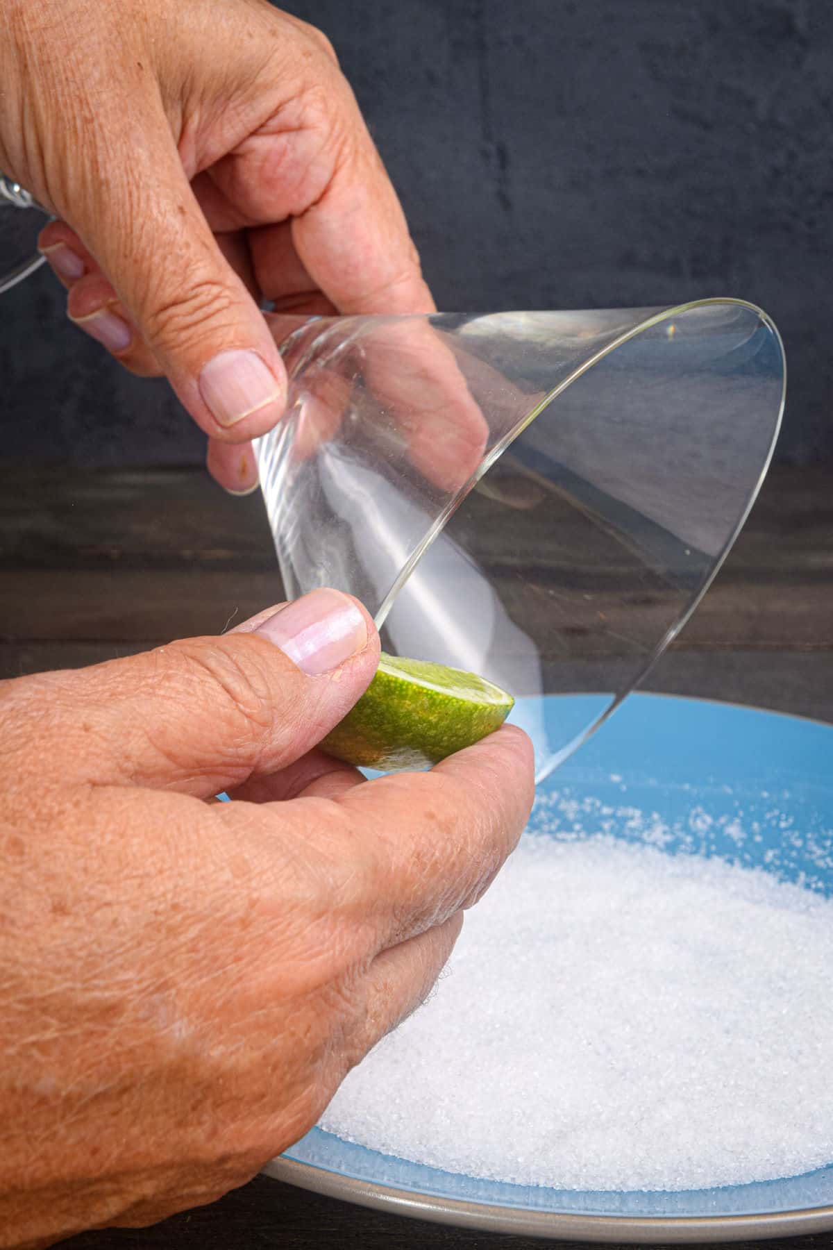 Lime wedge on martini glass rim.