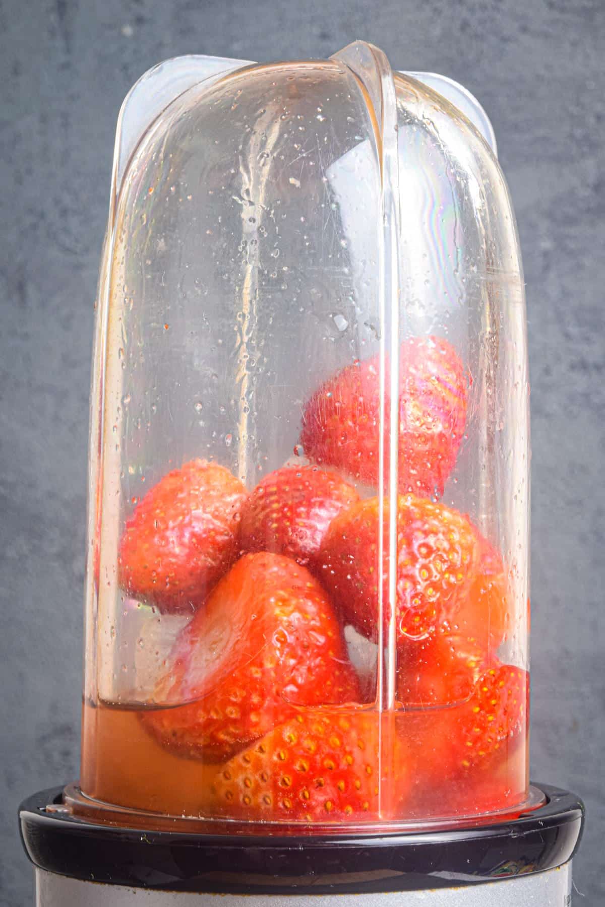Strawberry margarita slushy mixture in blender.