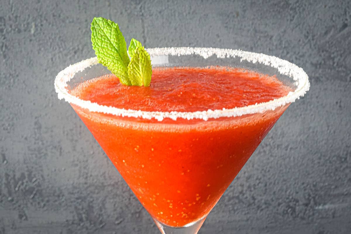 Slushy margarita in glass with mint.