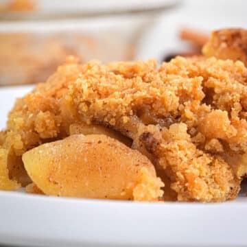 Apple crisp in white dish.