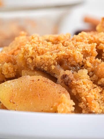 Apple crisp in white dish.