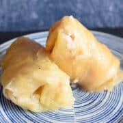 Cabbage rolls stacked on plate.
