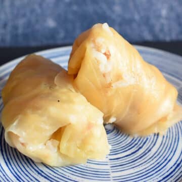 Cabbage rolls stacked on plate.