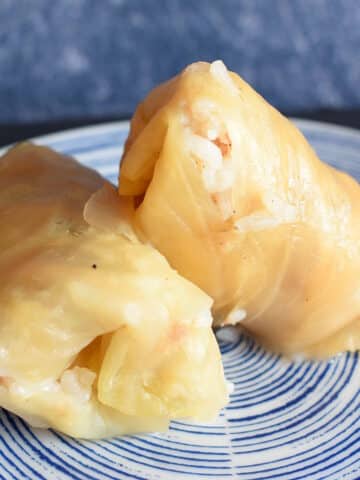 Cabbage rolls stacked on plate.