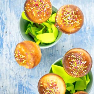 Cake mix cake pops in small pails with sprinkles on top.