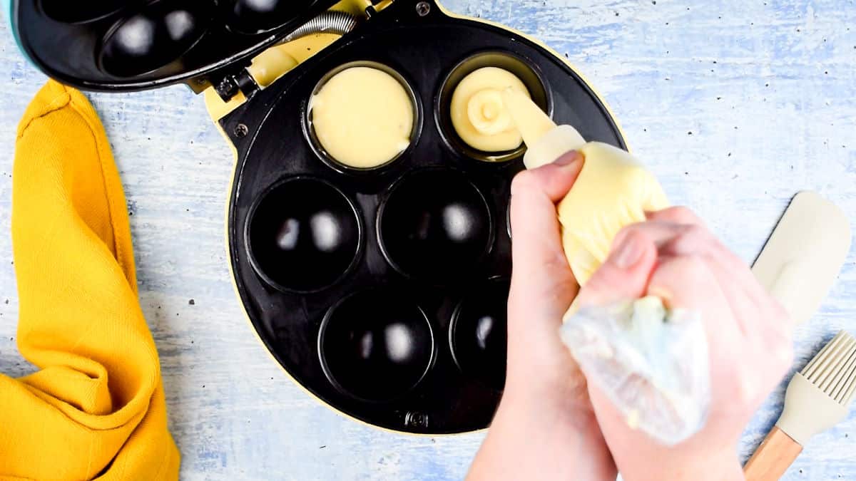 Cake pop maker getting filled with batter.