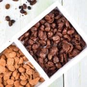 Chocolate covered coffee beans in white dish.