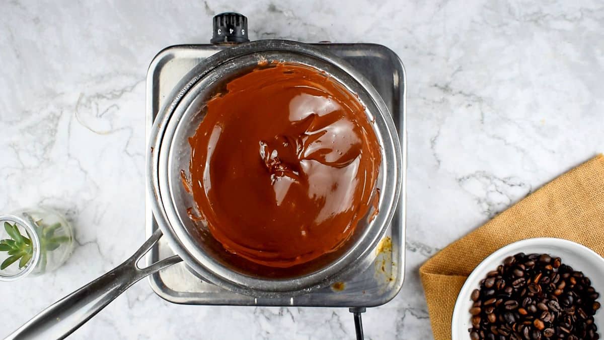 Melted chocolate in bowl over saucepan.