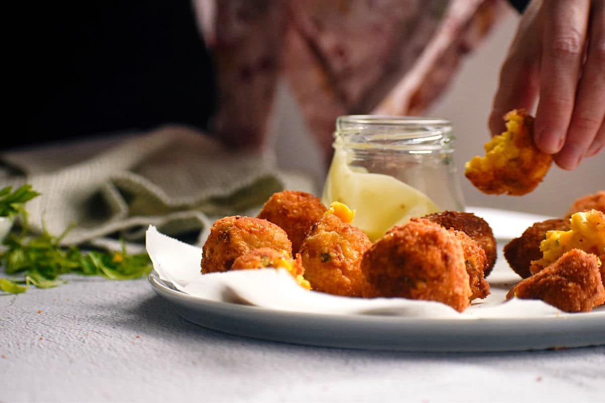 Fried corn nuggets on plate.