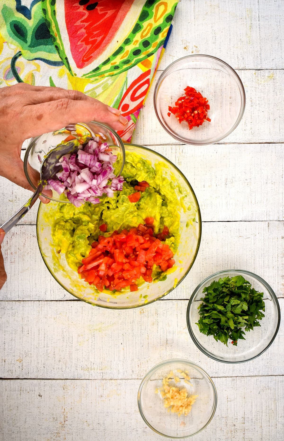 Guacamole ingredients combined in bowl.