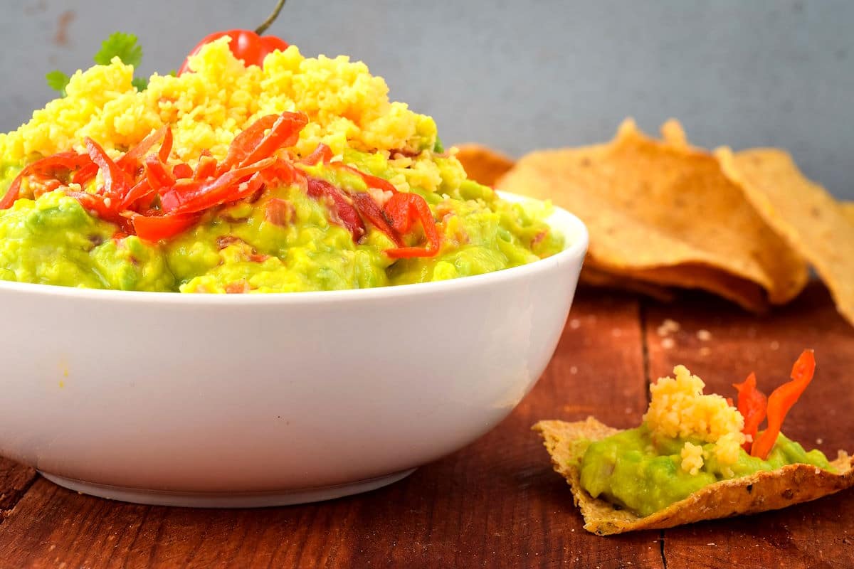 Spicy guacamole in a white bowl.