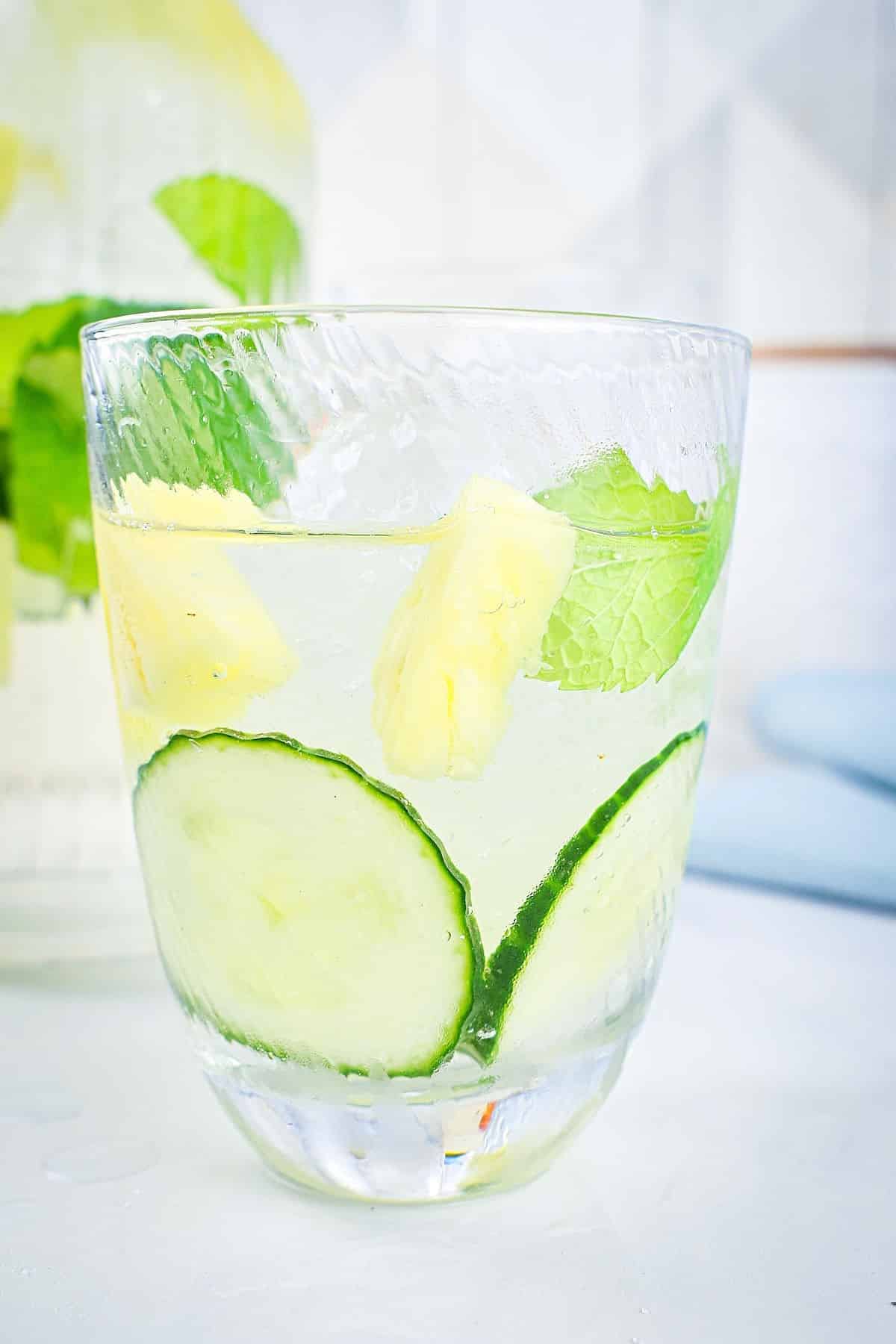 Cucumber, pineapple and mint infused water in glass.