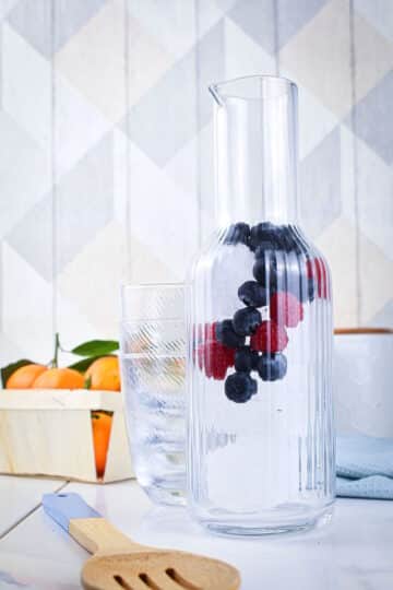 Ice and berries in pitcher.