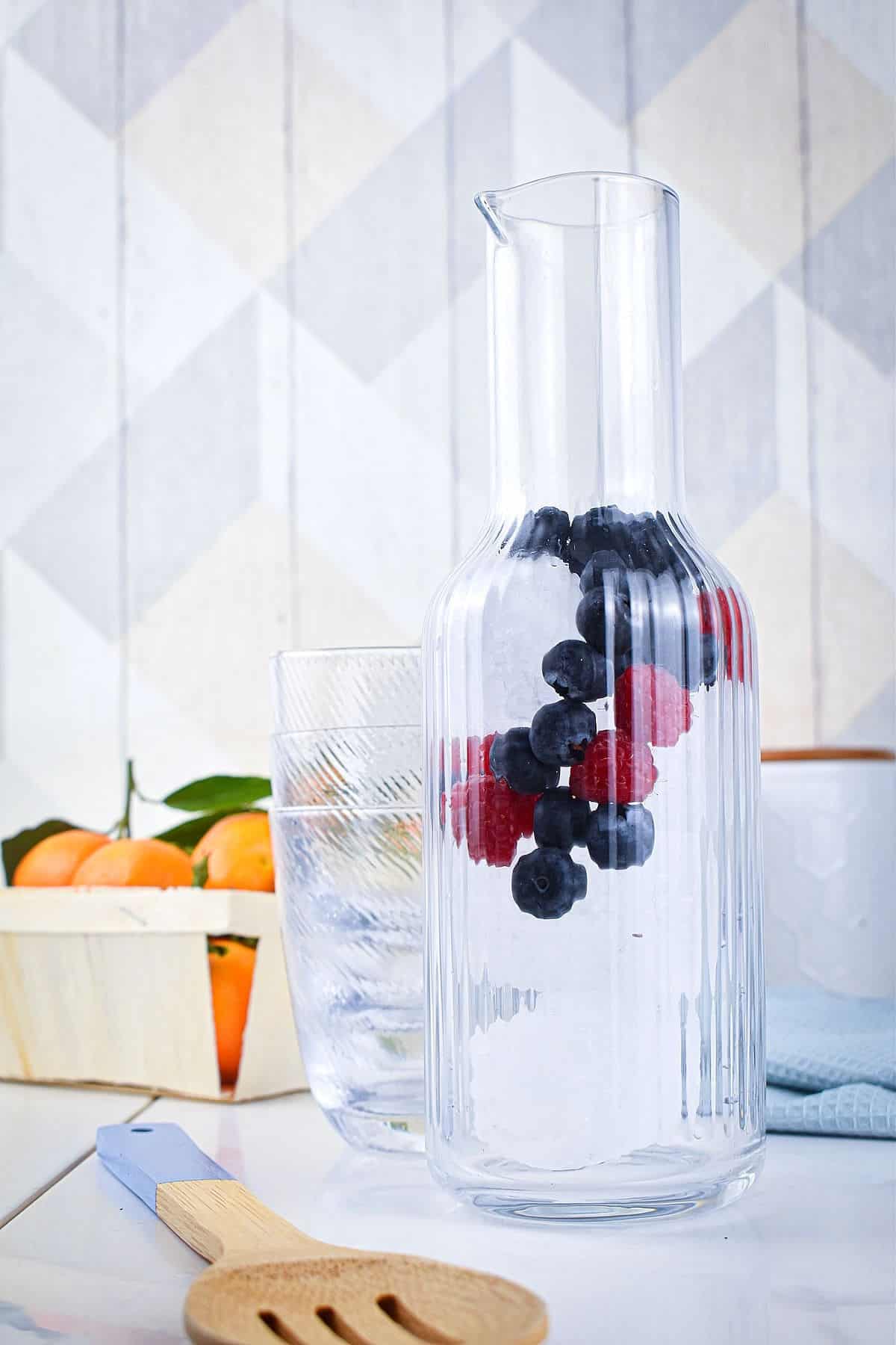 Ice and berries in pitcher.