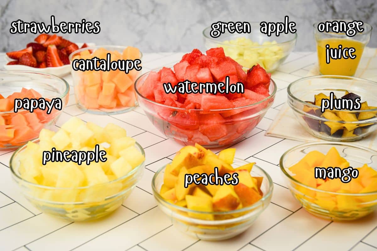 Fruit salad ingredients prepped and labeled.