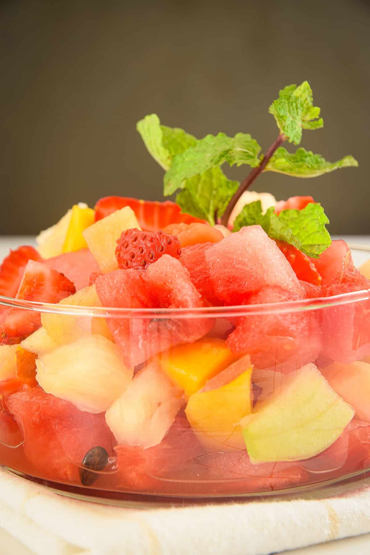 Fruit salad with a sprig of fresh mint.