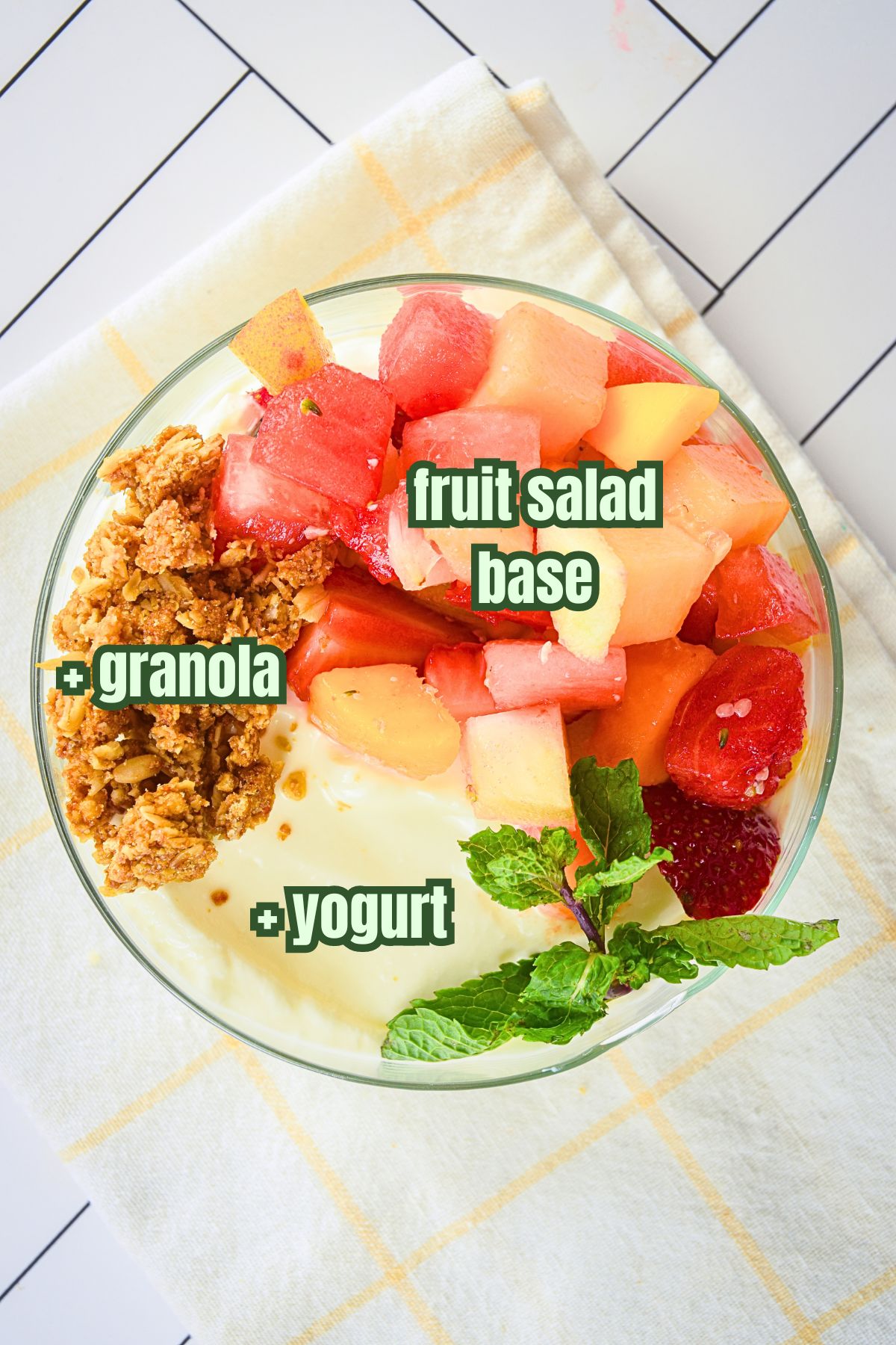 Fruit salad with yogurt and granola topping.