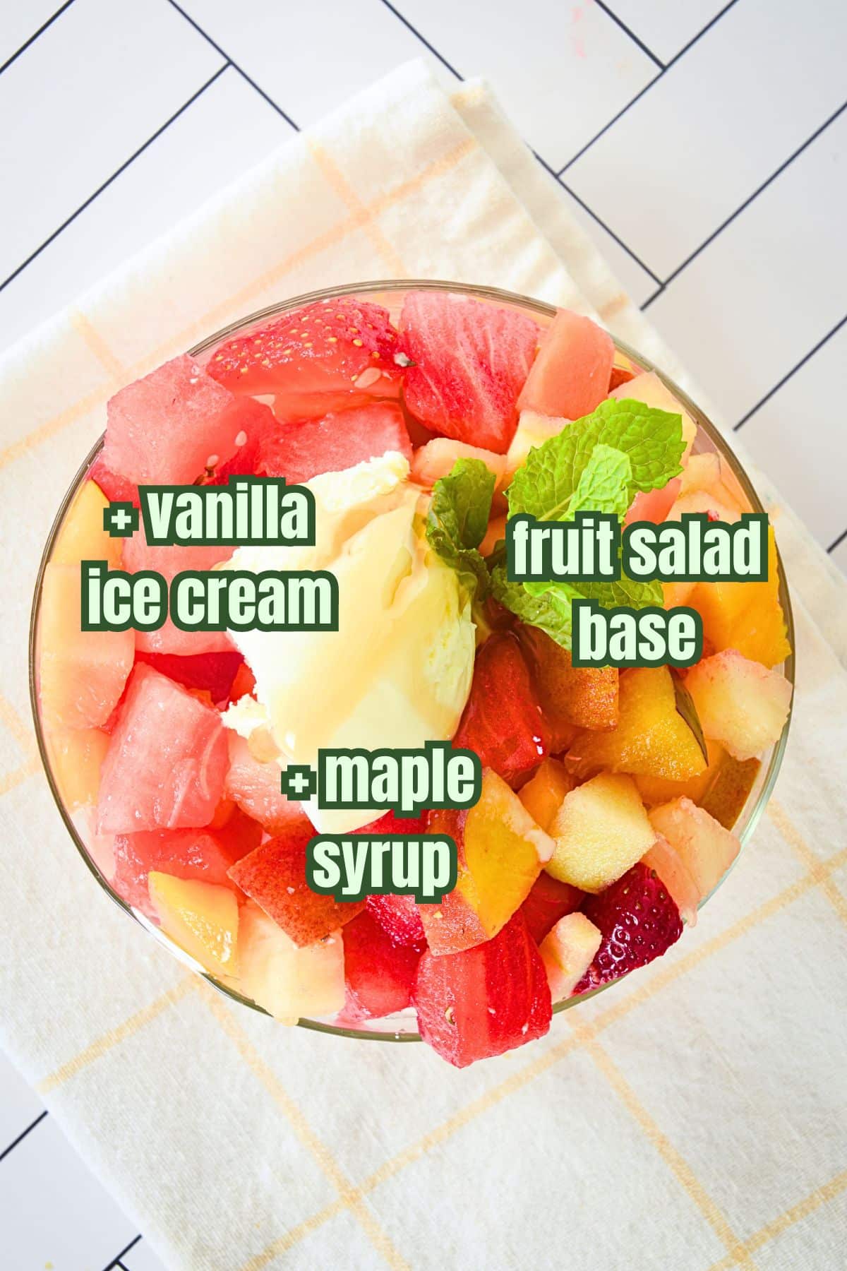 Fruit salad with ice cream and maple syrup topping.
