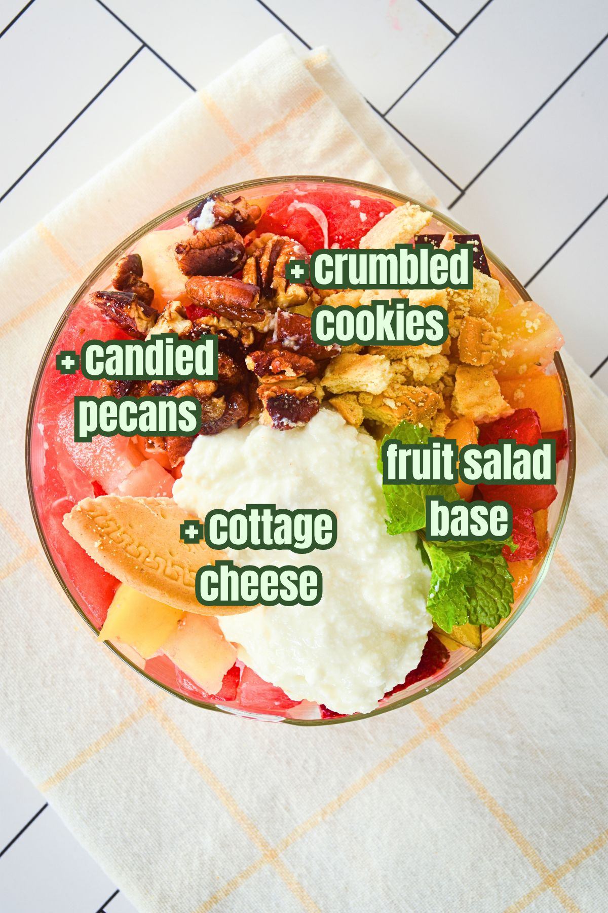 Fruit salad with candied pecans, crumbled cookies and cottage cheese topping.