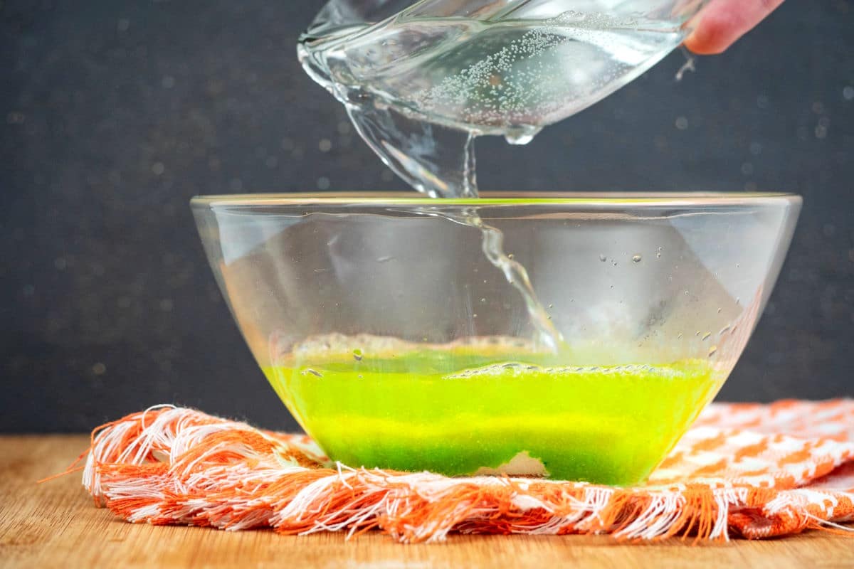 Green jello powder and warm water in small bowl.