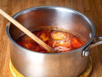 Tomatoes simmering in saucepan.