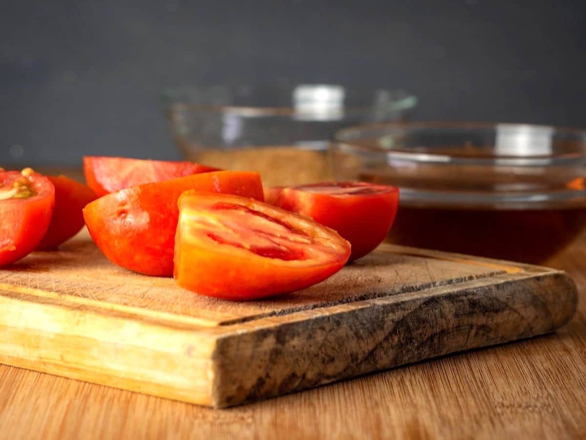 Fresh tomatoes on cutting board.