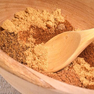 Pumpkin pie spices in bowl with spoon.