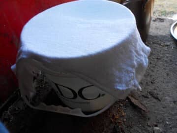 Pail with cheese cloth on top.