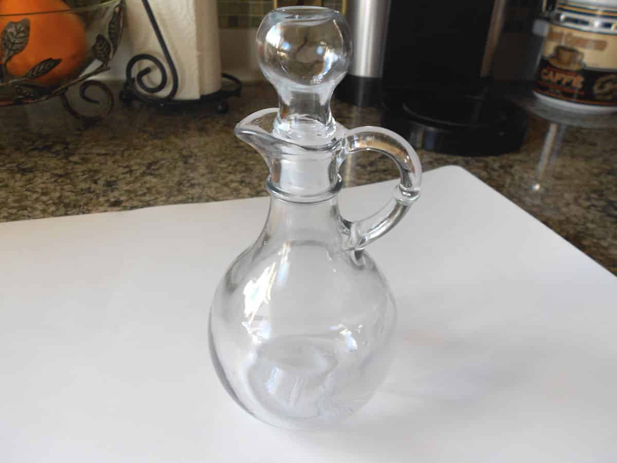 Empty maple syrup bottle on table.