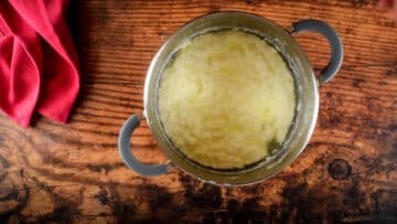 Ricotta cheese and whey in a pot.