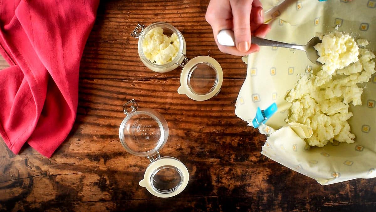Ricotta cheese in a strainer and jar.