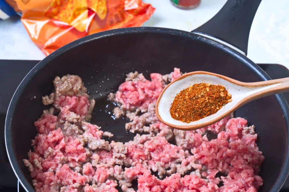 Ground meat in pan with taco seasoning.