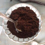 Vanilla bean powder in small dish with spoon.