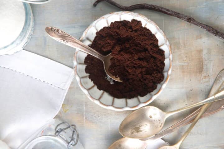 How to Make Vanilla Powder Final 1 Vanilla bean powder in small bowl with spoon.