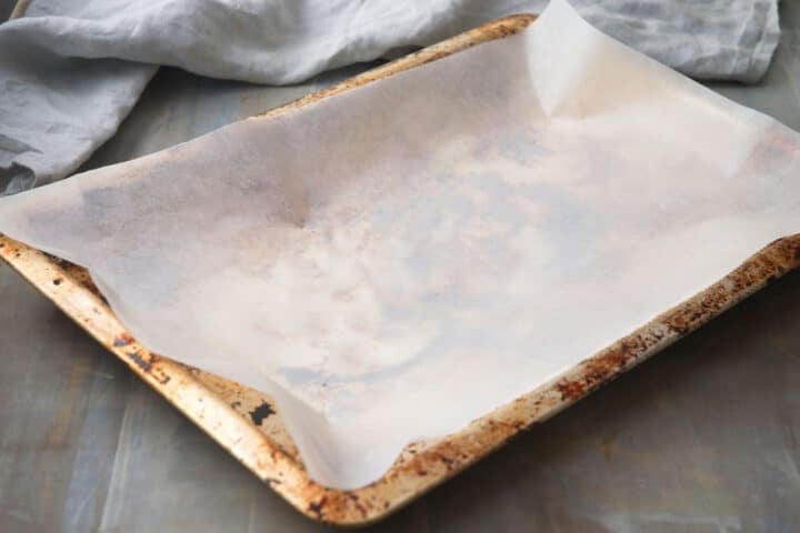How to Make Vanilla Powder Step 2 Parchment lined baking sheet.