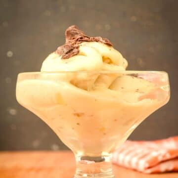 Homemade banana ice cream with chocolate shavings in a dessert glass.