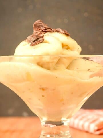 Homemade banana ice cream with chocolate shavings in a dessert glass.