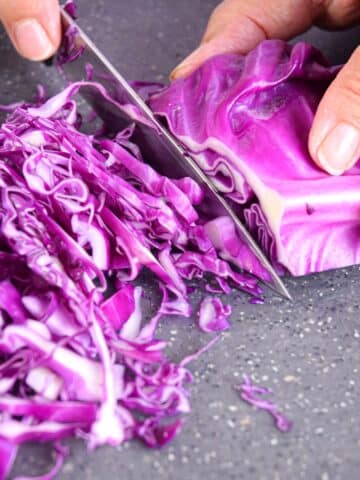 Red cabbage shredded with knife.