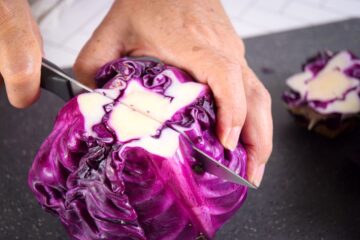 Red cabbage with knife down the middle.