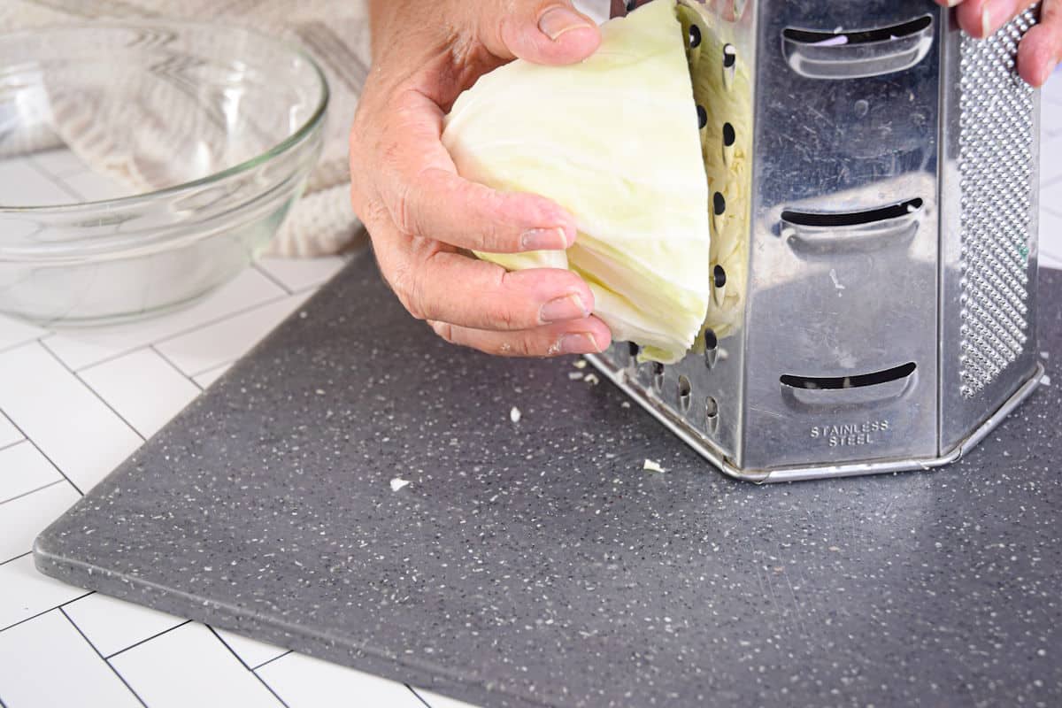 Green cabbage against box grater.