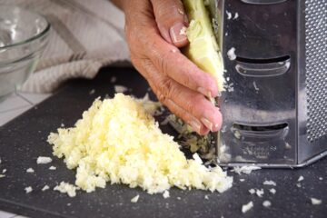 Green cabbage shredded with box grater.