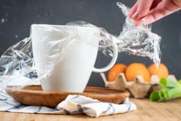 Plastic wrap in mug.