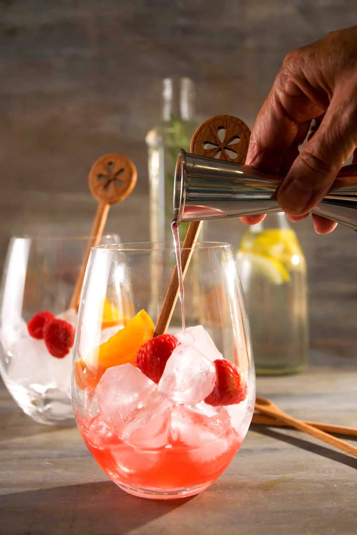 Wine glass with sangria, ice and cocktail syrup.