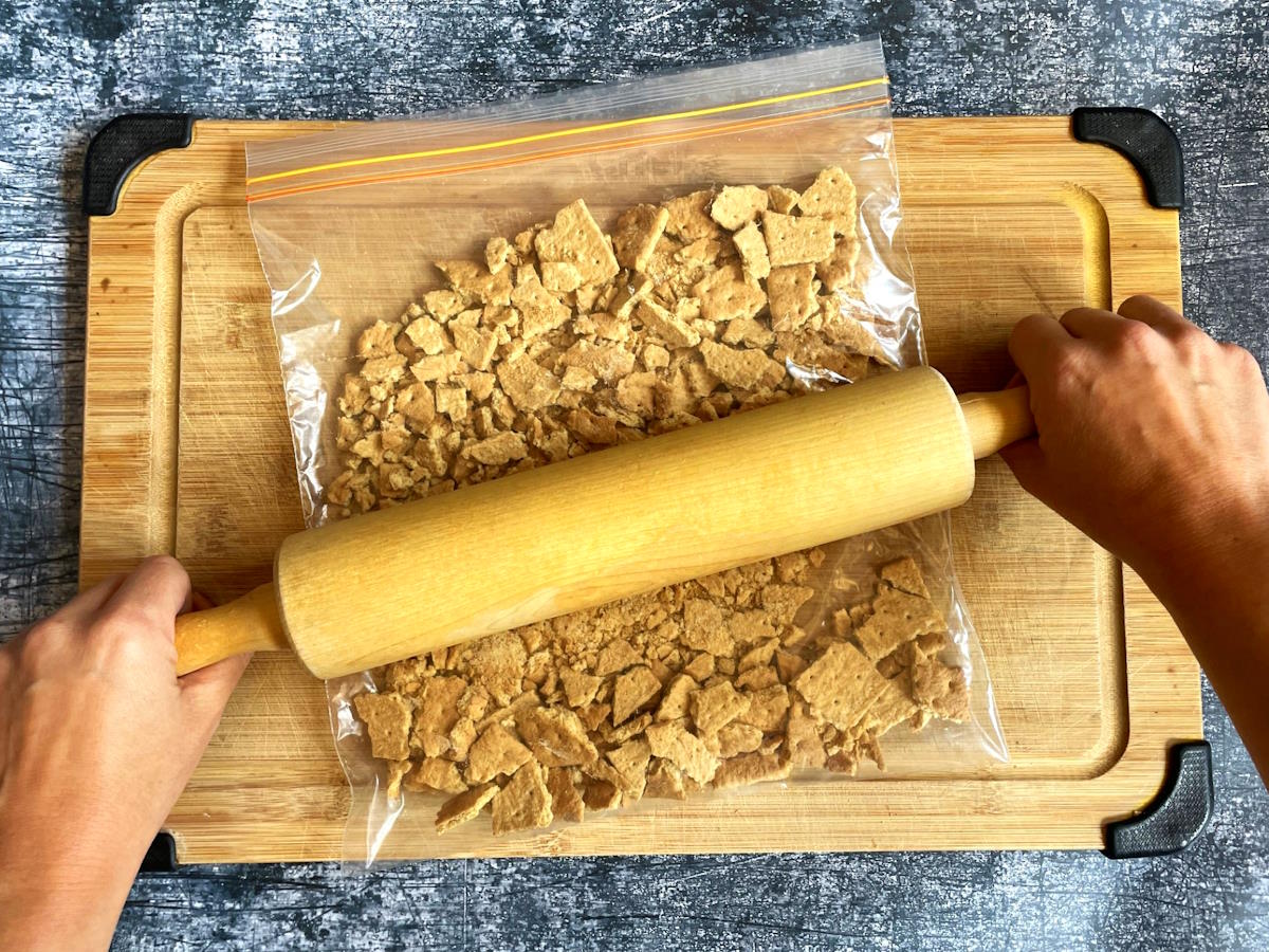 Graham crackers in bag with rolling pin.