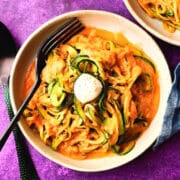Zucchini noodles in bowl with bocconcini.