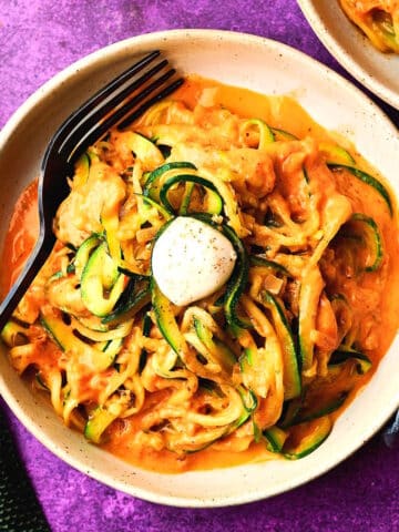 Zucchini noodles in bowl with bocconcini.
