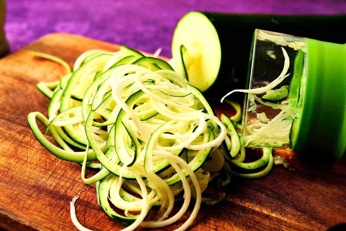 Spiralized zucchini noodles on cutting board.