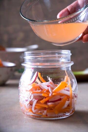 Julienned veggies in jar with pickling brine.