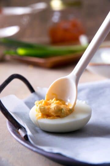 Deviled egg mixture in cooked egg white.